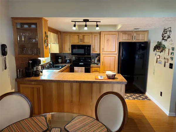 a kitchen with stainless steel appliances a stove refrigerator sink and microwave