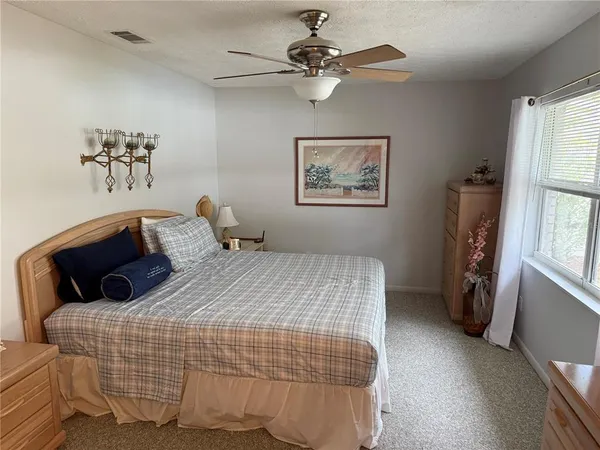 a room with a bed and a chandelier