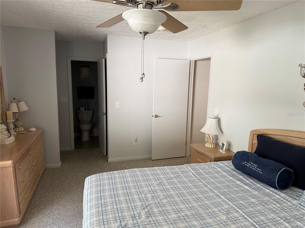 4007 Truman Drive Seffner, FL 33584 - Photo 10 of 17 a bedroom with a bed and a chair