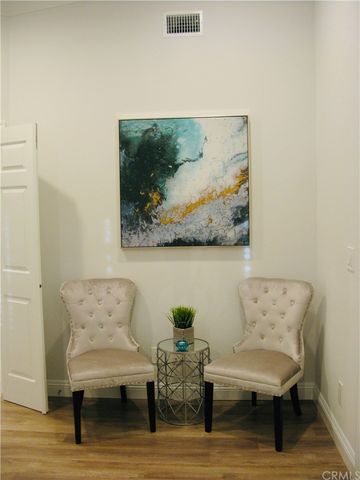 a living room with furniture and a wall painting