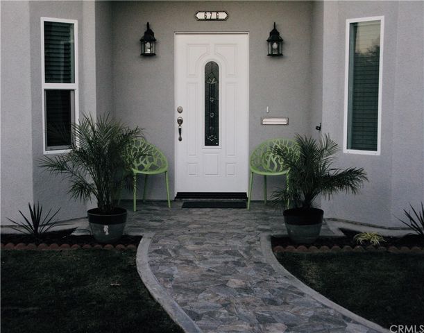 a potted plant sitting in front of a house