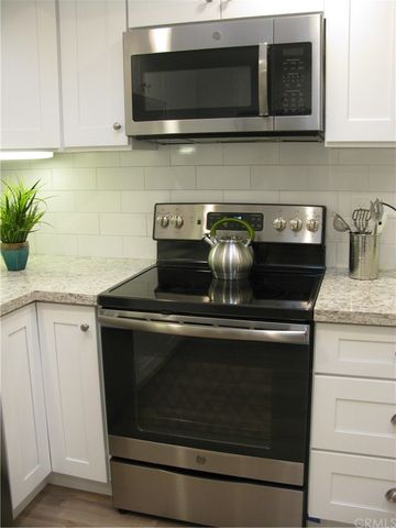 a stove top oven sitting inside of a kitchen