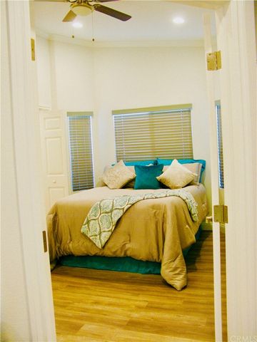 a bedroom with a bed and a painting on the wall