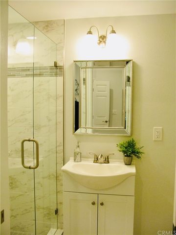 a bathroom with a sink a mirror and shower