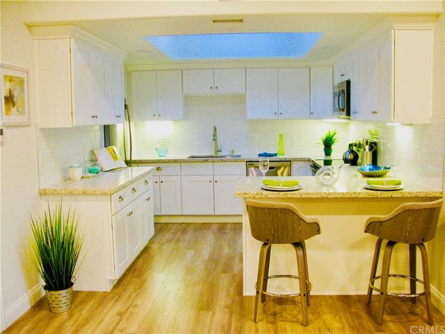 a kitchen with a sink cabinets and window