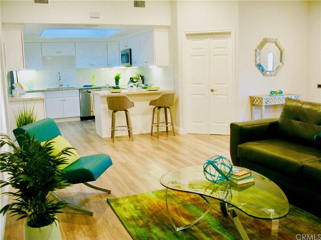 a living room with kitchen island furniture and a wooden floor