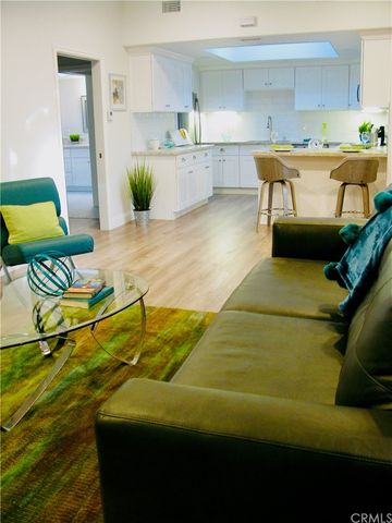 a living room with a couch and wooden floor