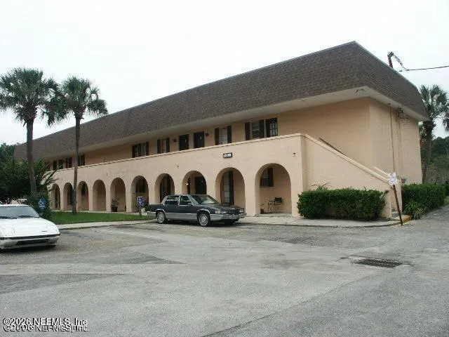 a view of building with parking space