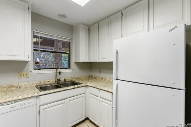 a kitchen with sink and cabinets