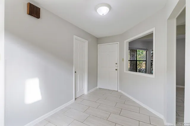 a view of an empty room with a window