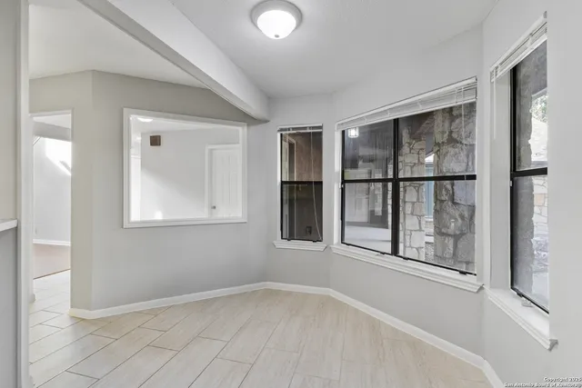 a kitchen with cabinets and window