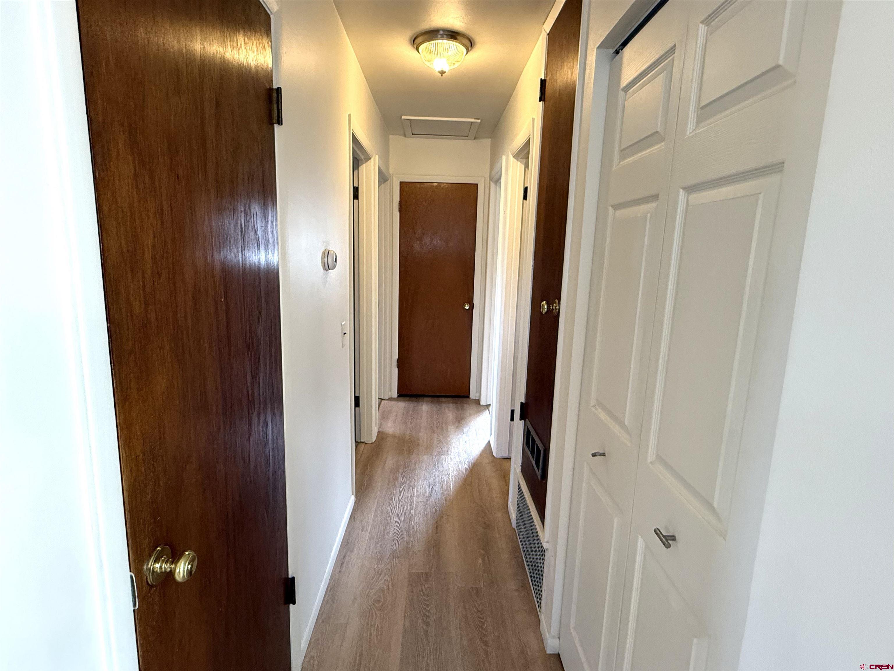 801 East 3rd Street Cortez, CO 81321 - Photo 14 of 22 a view of a hallway with wooden floor