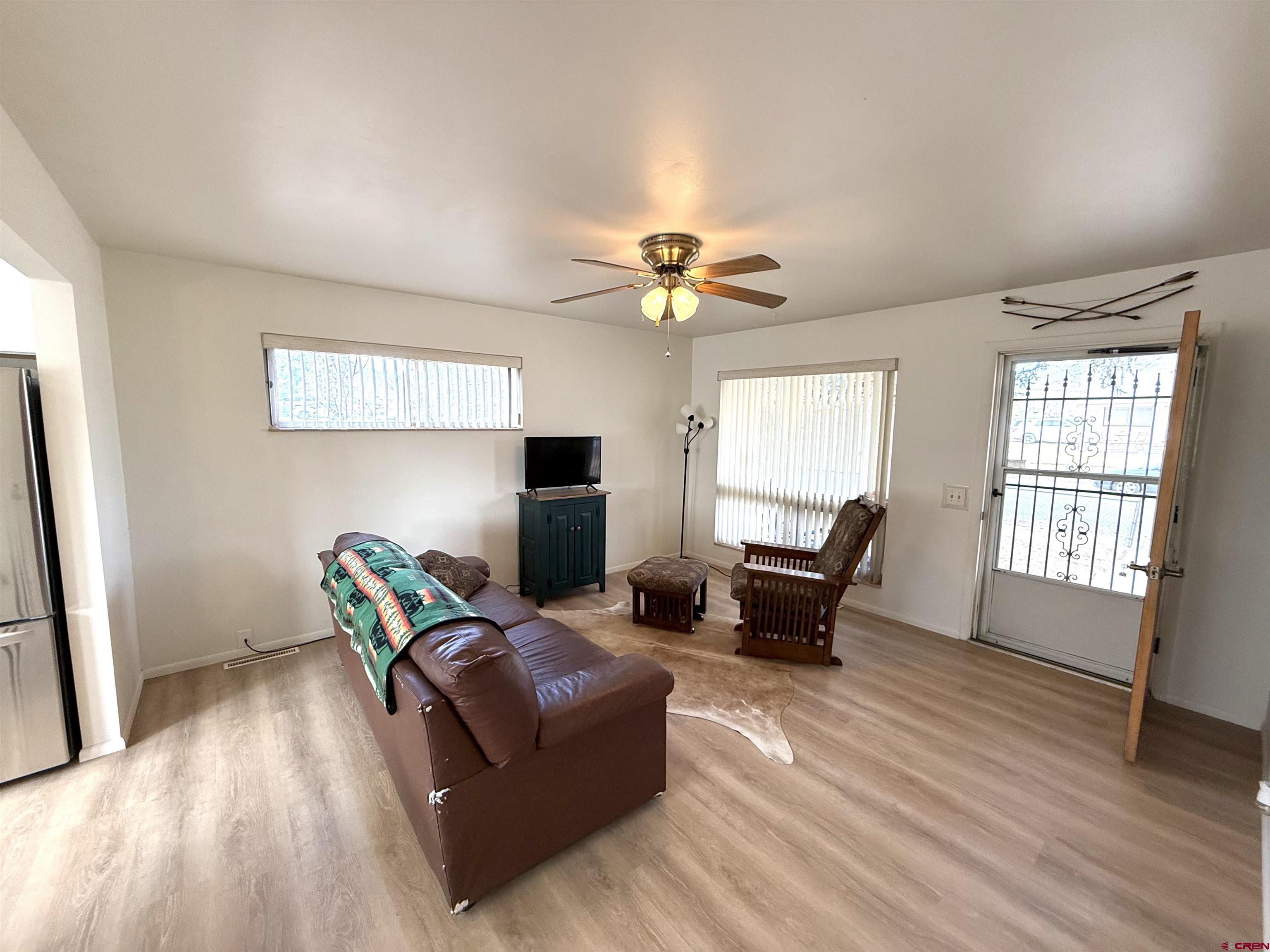 801 East 3rd Street Cortez, CO 81321 - Photo 18 of 22 a living room with furniture and wooden floor