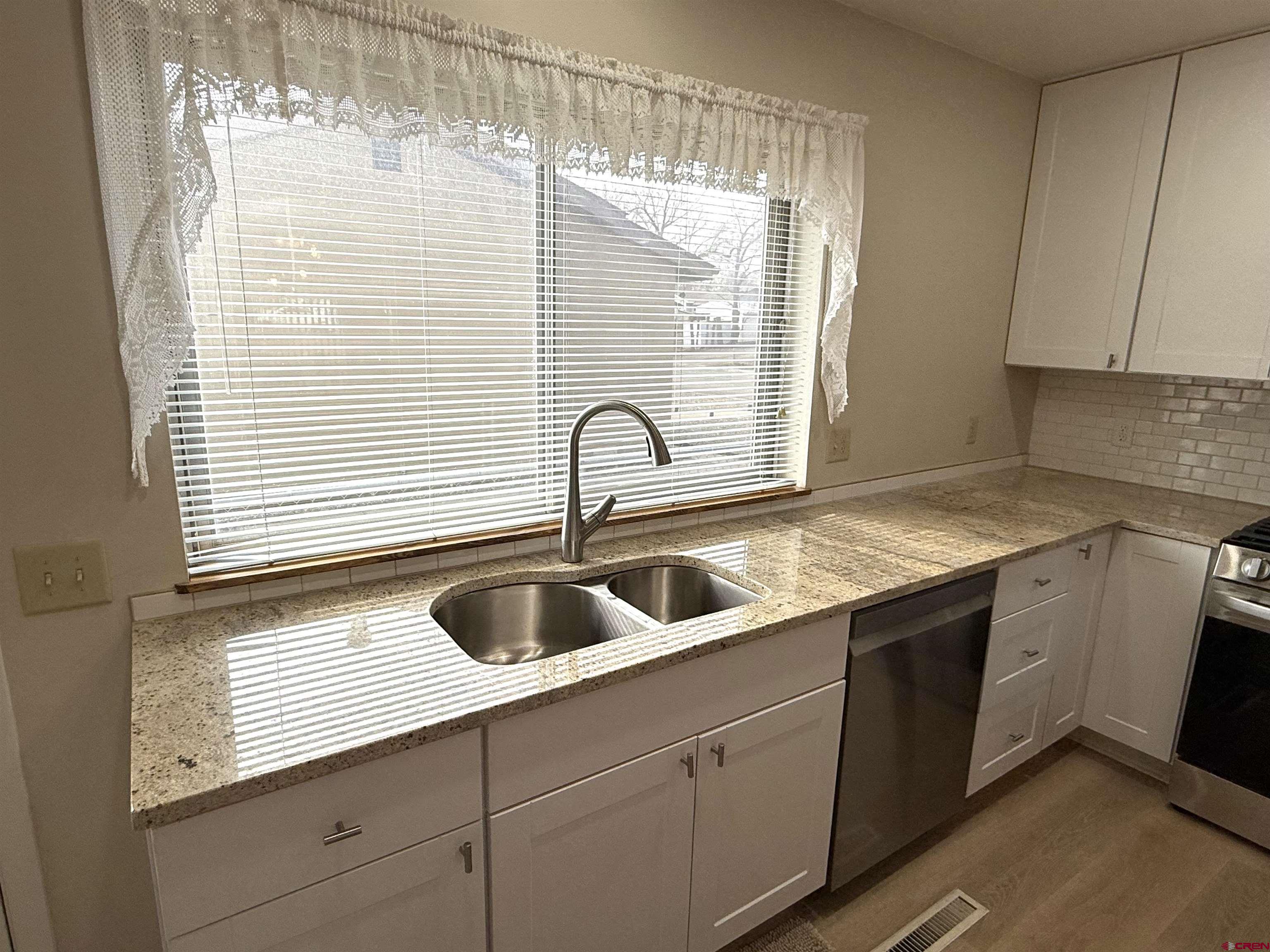 801 East 3rd Street Cortez, CO 81321 - Photo 21 of 22 a kitchen with a sink and cabinets