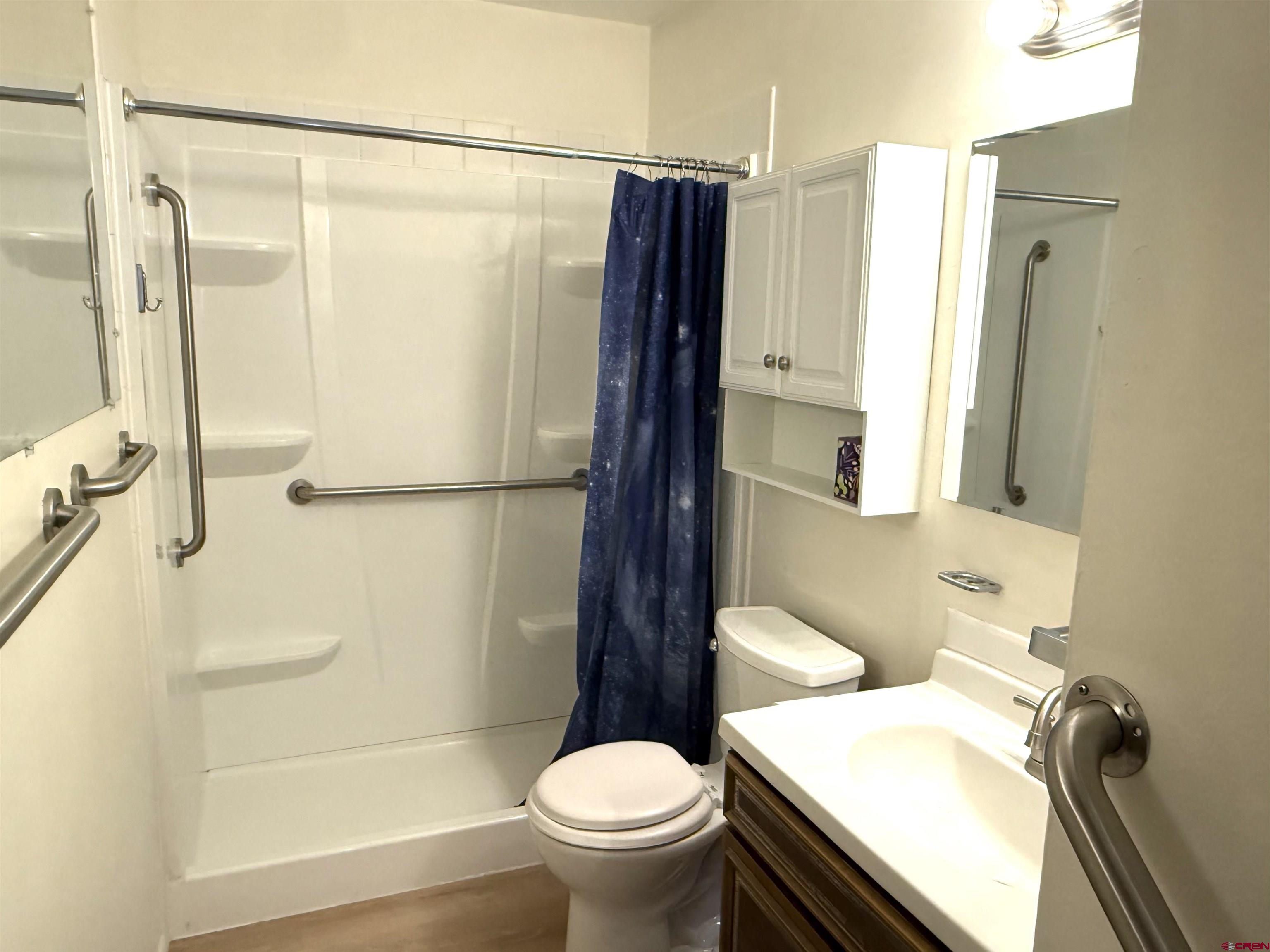 801 East 3rd Street Cortez, CO 81321 - Photo 4 of 22 a bathroom with a sink toilet and shower
