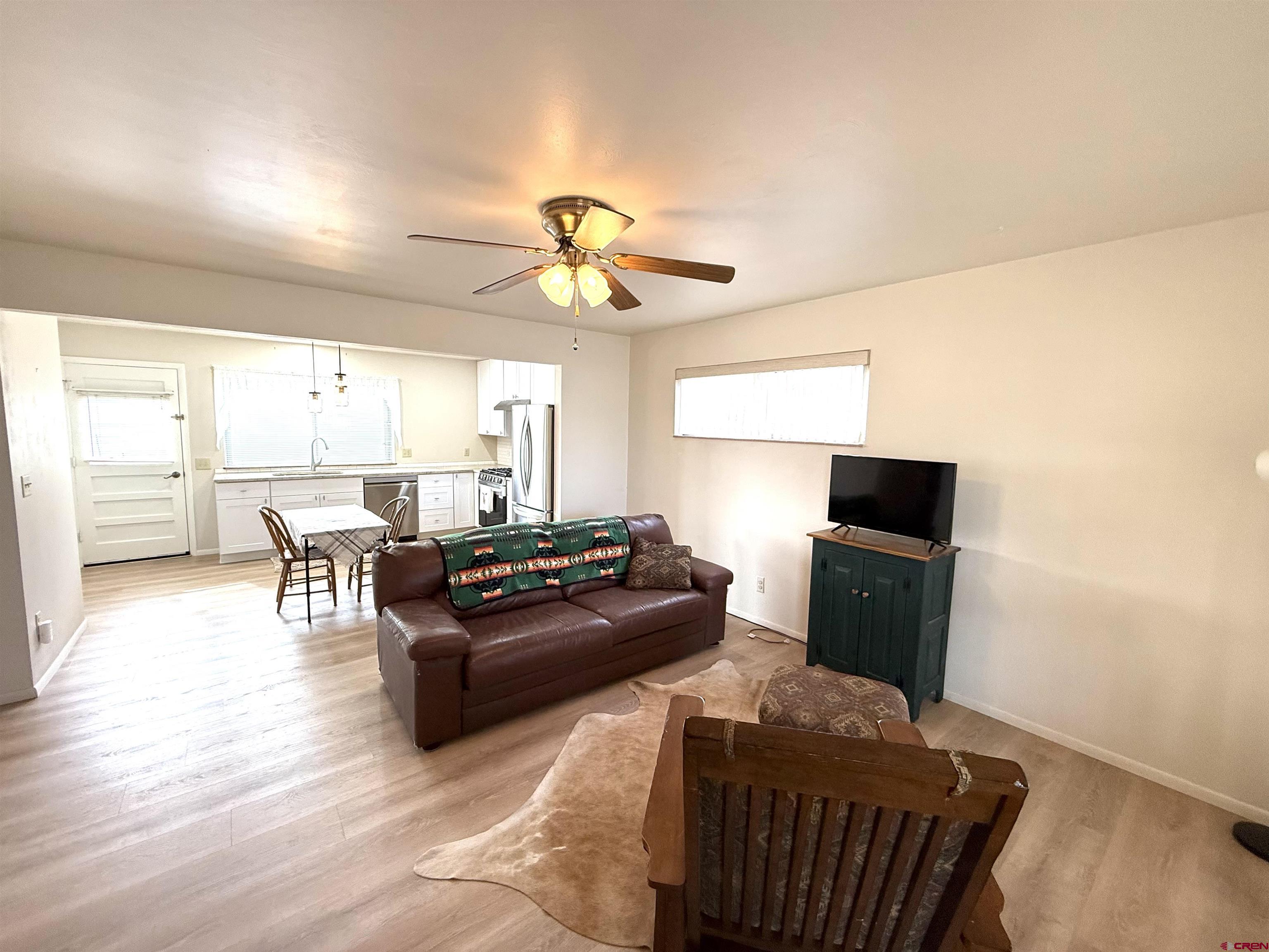 801 East 3rd Street Cortez, CO 81321 - Photo 10 of 22 a living room with furniture a large window and a flat screen tv