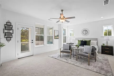 a living room with furniture a fireplace and a table