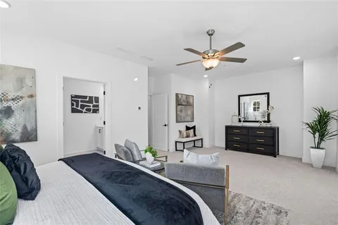 a bedroom with a bed and ceiling fan