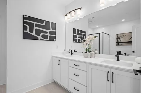 a bathroom with a double vanity sink mirror and