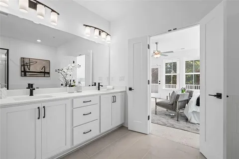 a spacious bathroom with a double vanity sink and a mirror