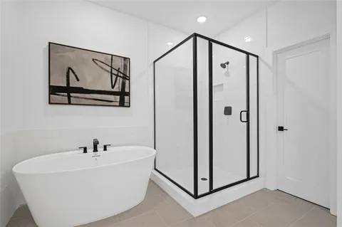 a white tub sitting next to a bathroom sink