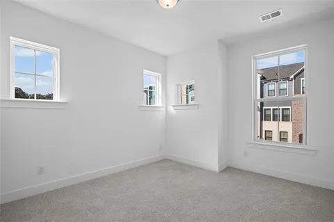 an empty room with windows and closet