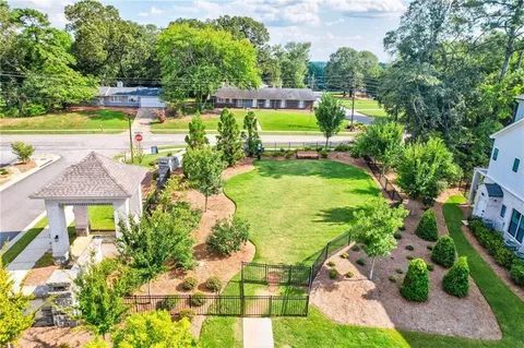 an aerial view of a house with garden space and swimming pool