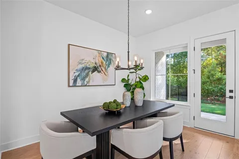 a dining room with furniture and wooden floor