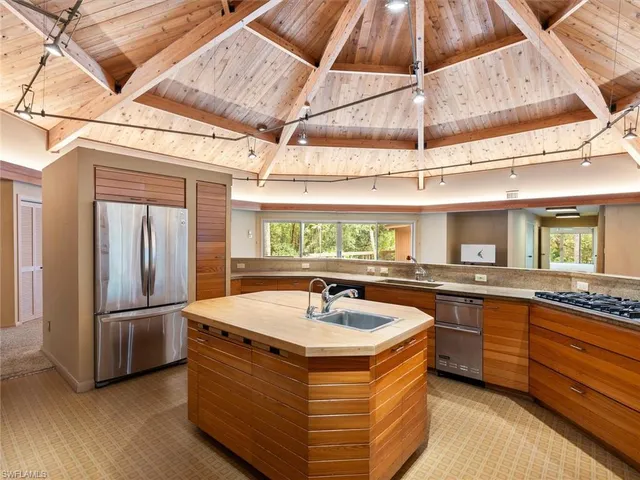 a room with pool table and windows