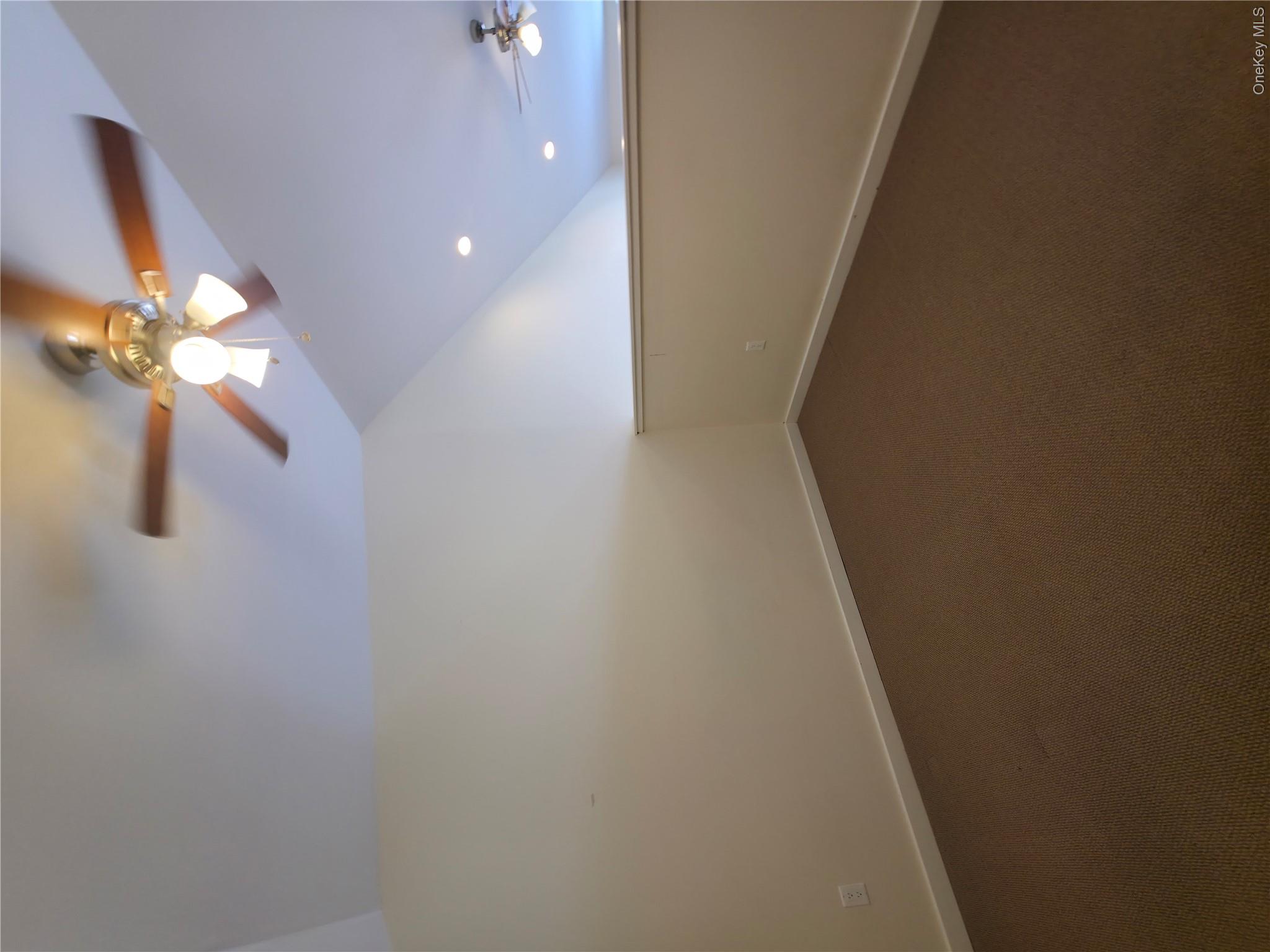 231 Reynolds Road, Unit 11 Loch Sheldrake, NY 12759 - Photo 17 of 20 Empty room with lofted ceiling, ceiling fan, dark carpet, and baseboards