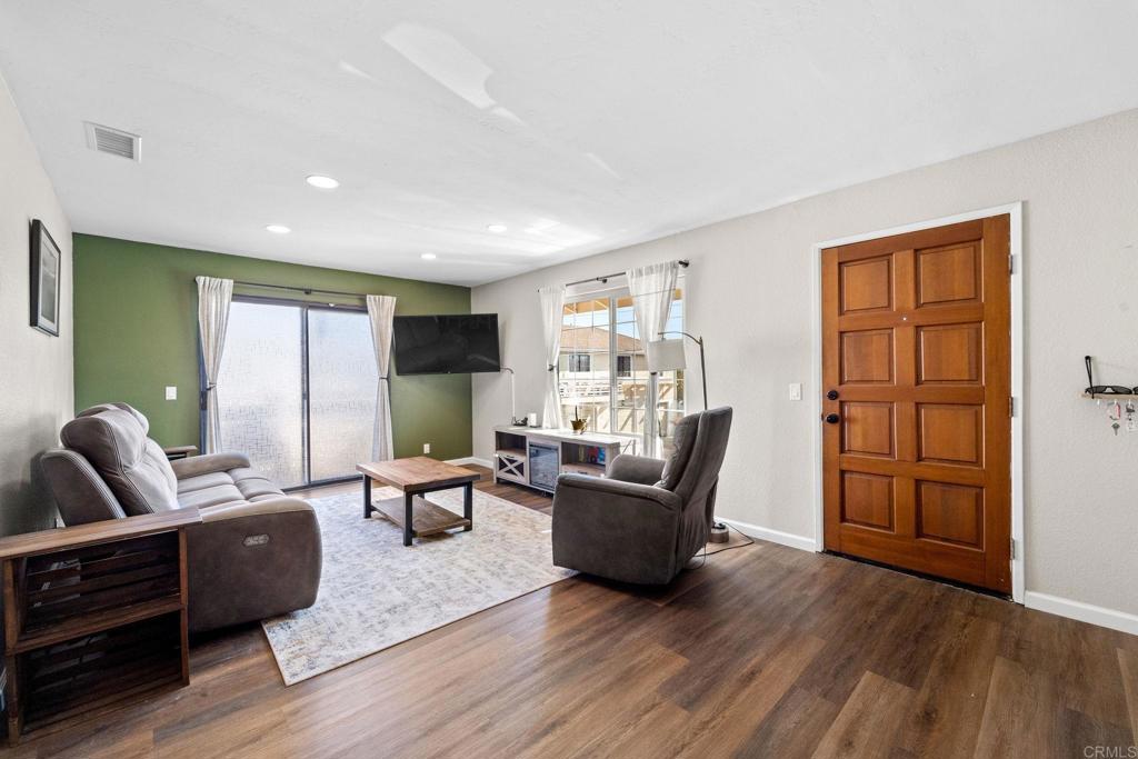 a living room with furniture and wooden floors