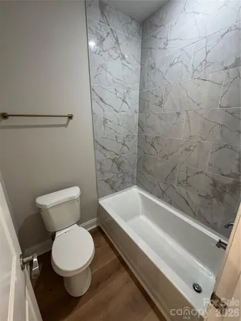 a bathroom with a toilet and a bathtub