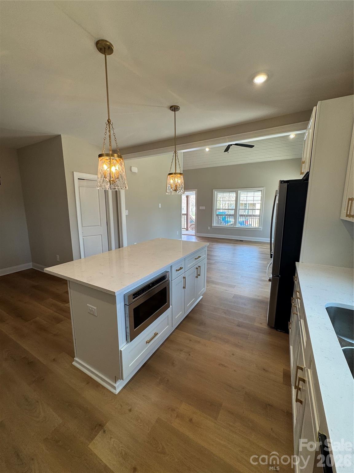 203 Lee Street Fort Mill, SC 29715 - Photo 2 of 19 a kitchen with a stove and a wooden floor