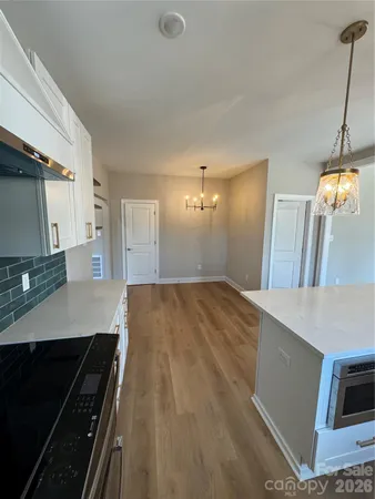 a view of a kitchen with a sink and a stove top oven