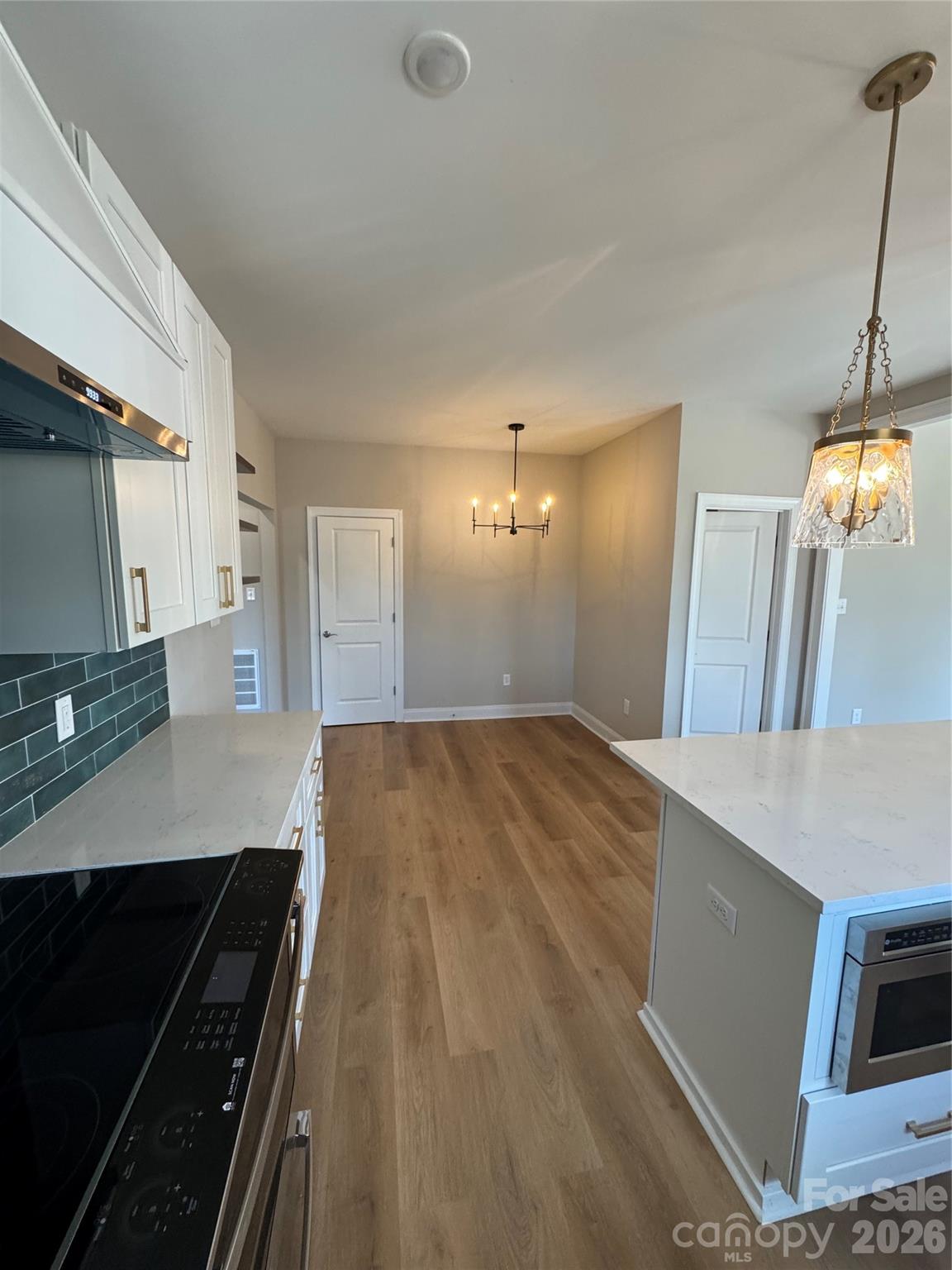 203 Lee Street Fort Mill, SC 29715 - Photo 4 of 19 a view of a kitchen with a sink and a stove top oven