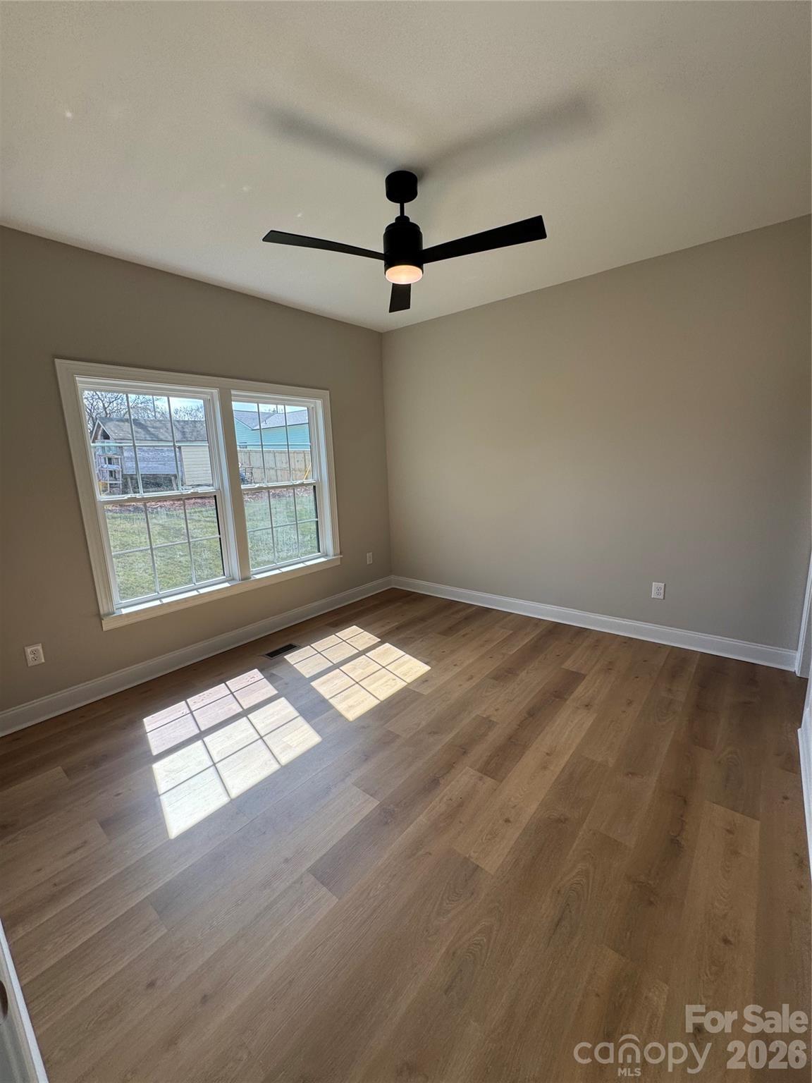 203 Lee Street Fort Mill, SC 29715 - Photo 7 of 19 wooden floor in an empty room with a window