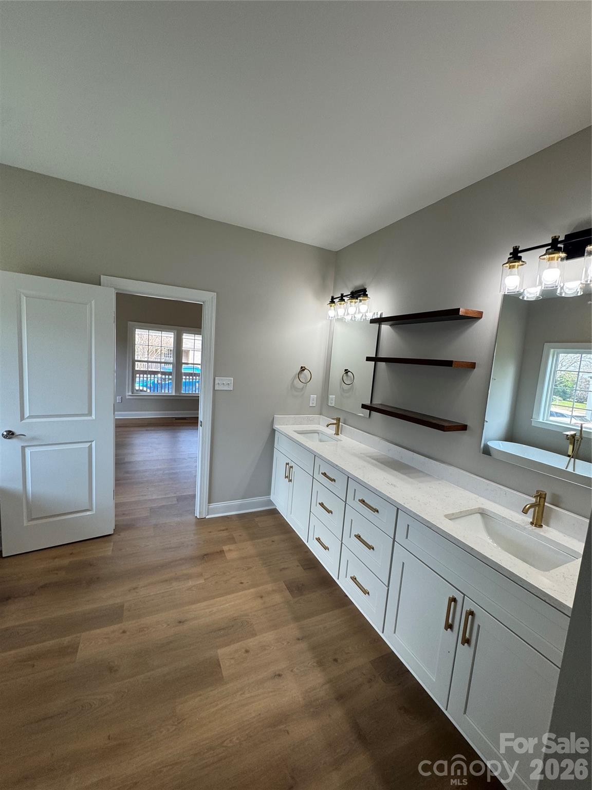203 Lee Street Fort Mill, SC 29715 - Photo 9 of 19 a spacious bathroom with double vanity and a mirror