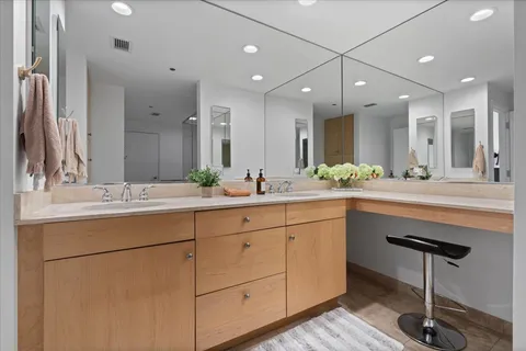 a bathroom with a sink shower and a mirror