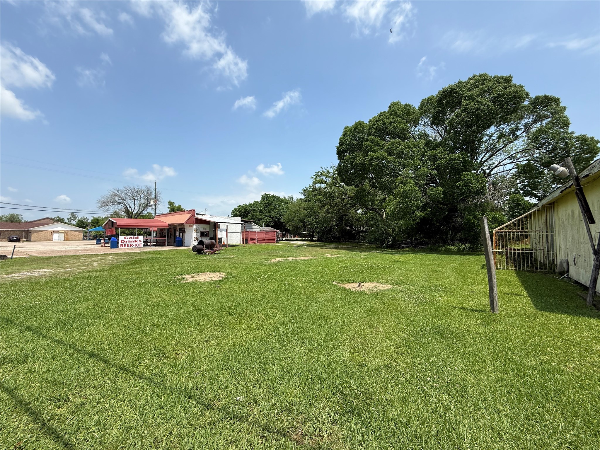 a view of yard with swimming pool and green space