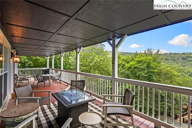 a view of a patio with chairs and a potted plant