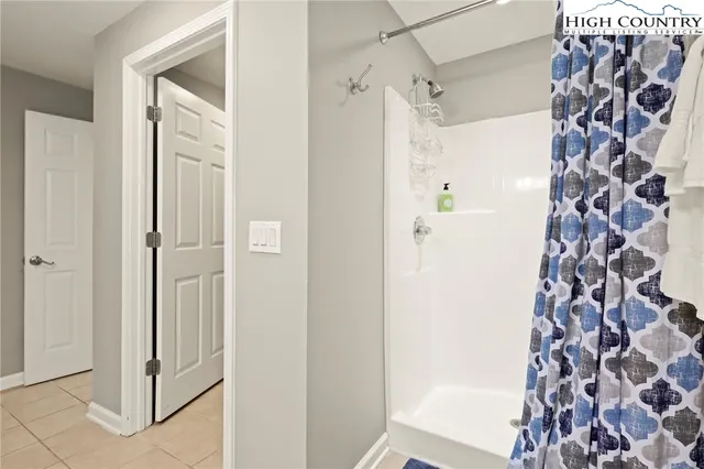 a bathroom with a shower and a mirror