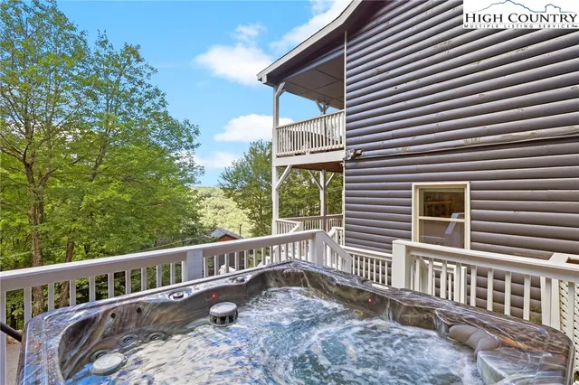 a view of a house with a small yard and wooden fence
