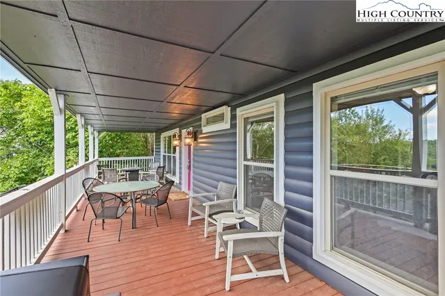 a balcony with chairs and wooden floor