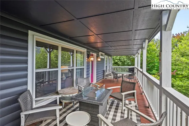 a view of a patio with chairs and floor to ceiling window