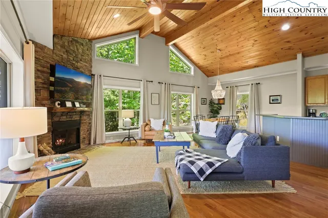 a living room with furniture a fireplace and a table