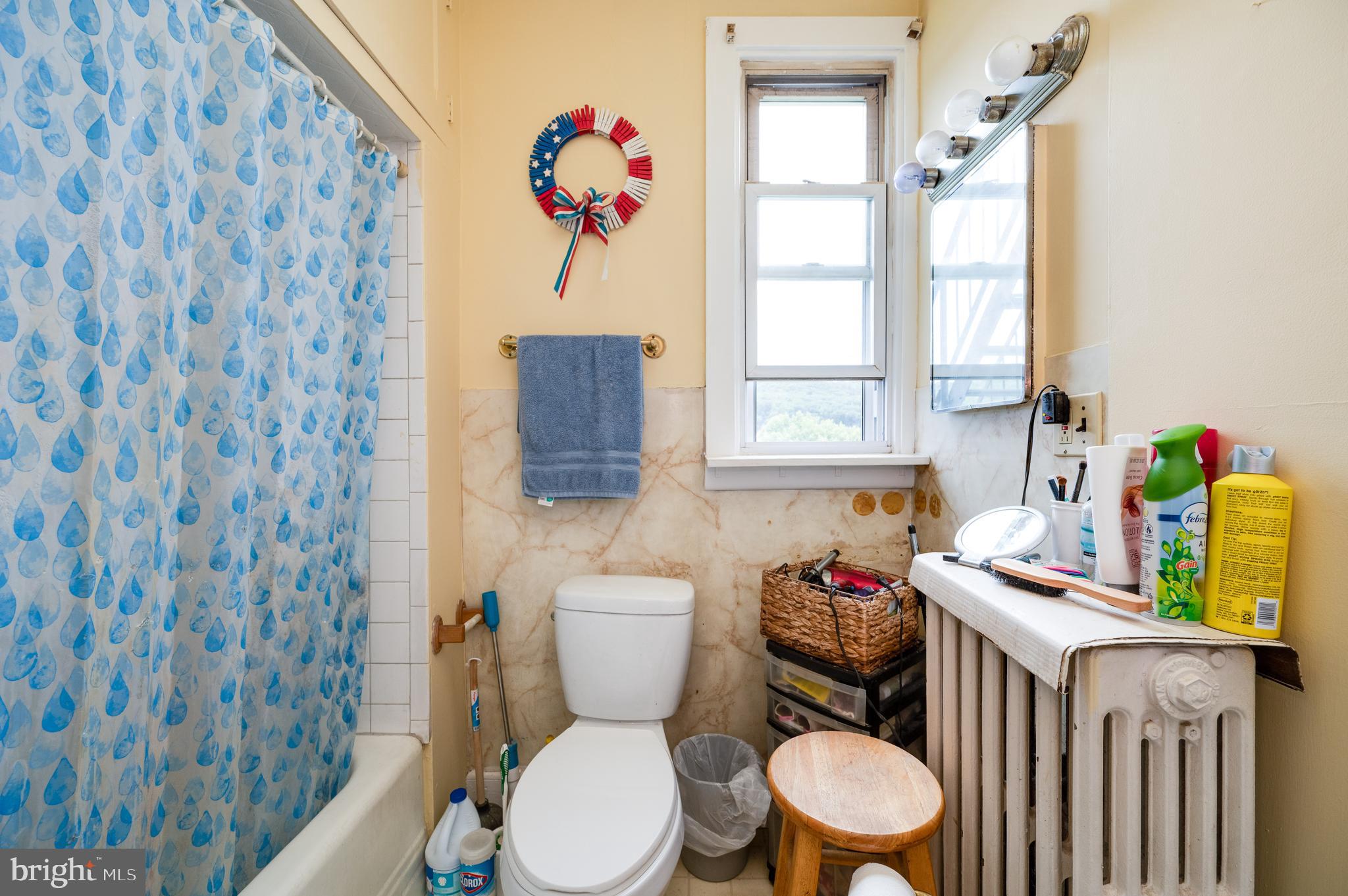 1642 Mineral Spring Road Reading, PA 19602 - Photo 21 of 56 a white toilet sitting next to a bathroom sink and a window