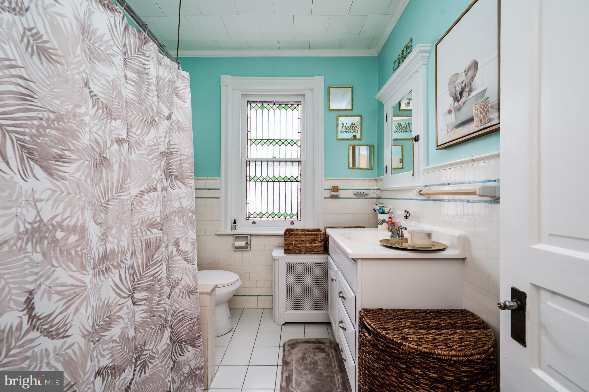 1642 Mineral Spring Road Reading, PA 19602 - Photo 31 of 56 a bathroom with a sink toilet and window