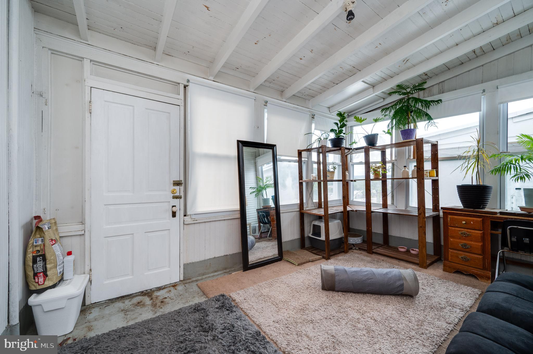 1642 Mineral Spring Road Reading, PA 19602 - Photo 37 of 56 a living room with furniture a flat screen tv and a window