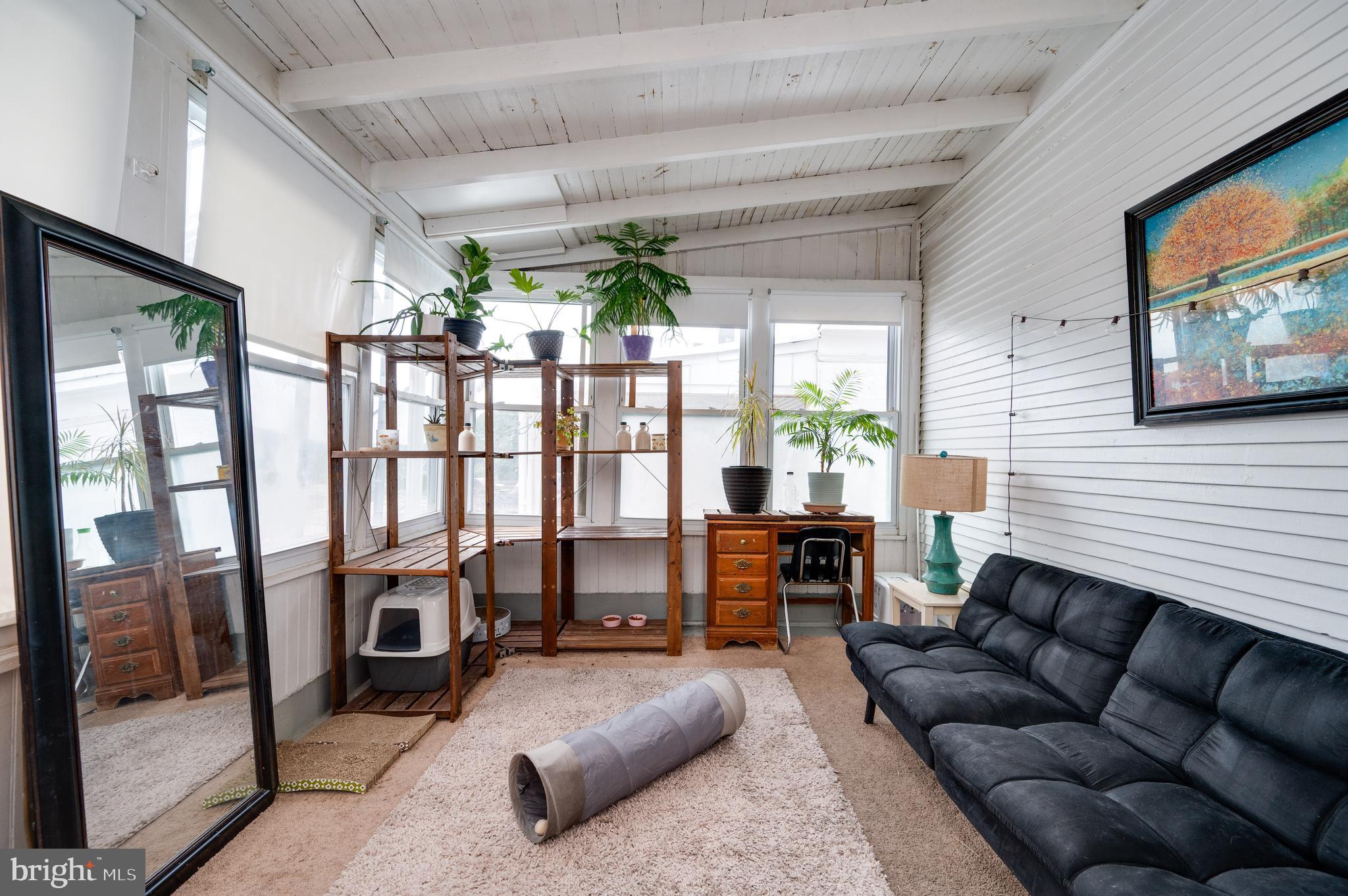 1642 Mineral Spring Road Reading, PA 19602 - Photo 39 of 56 a living room with furniture and a flat screen tv