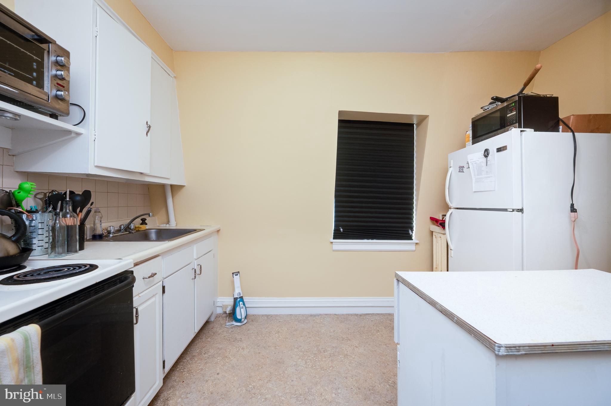 1642 Mineral Spring Road Reading, PA 19602 - Photo 46 of 56 a kitchen with a sink a refrigerator and a stove